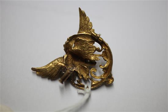 A pierced 18ct gold and diamond winged gargoyle brooch, 1.25in.